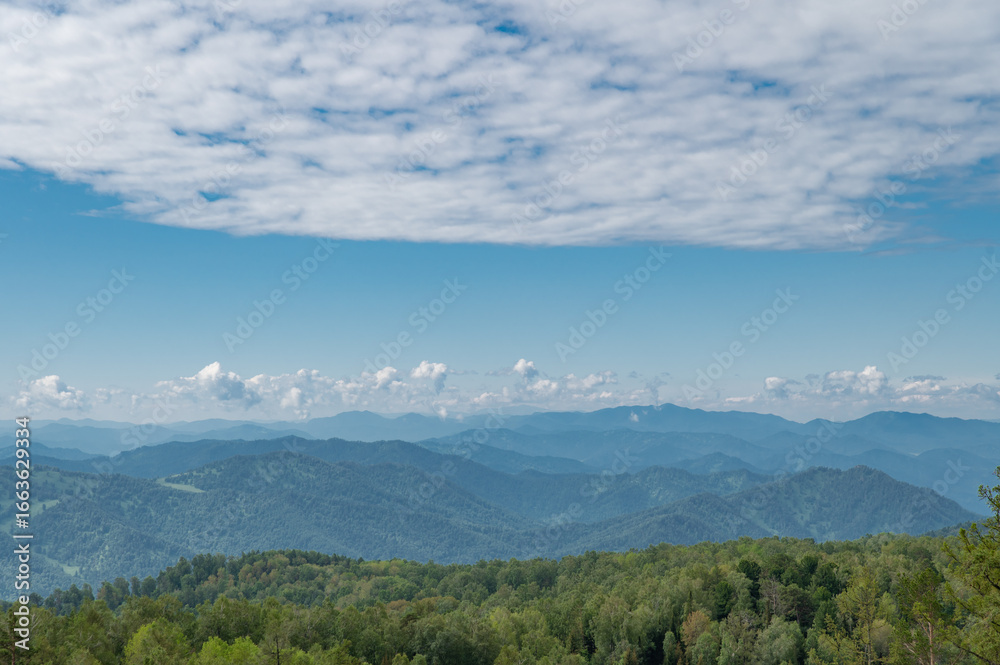 Obraz premium The mountain tops are covered with snow and illuminated by the reddish morning light.