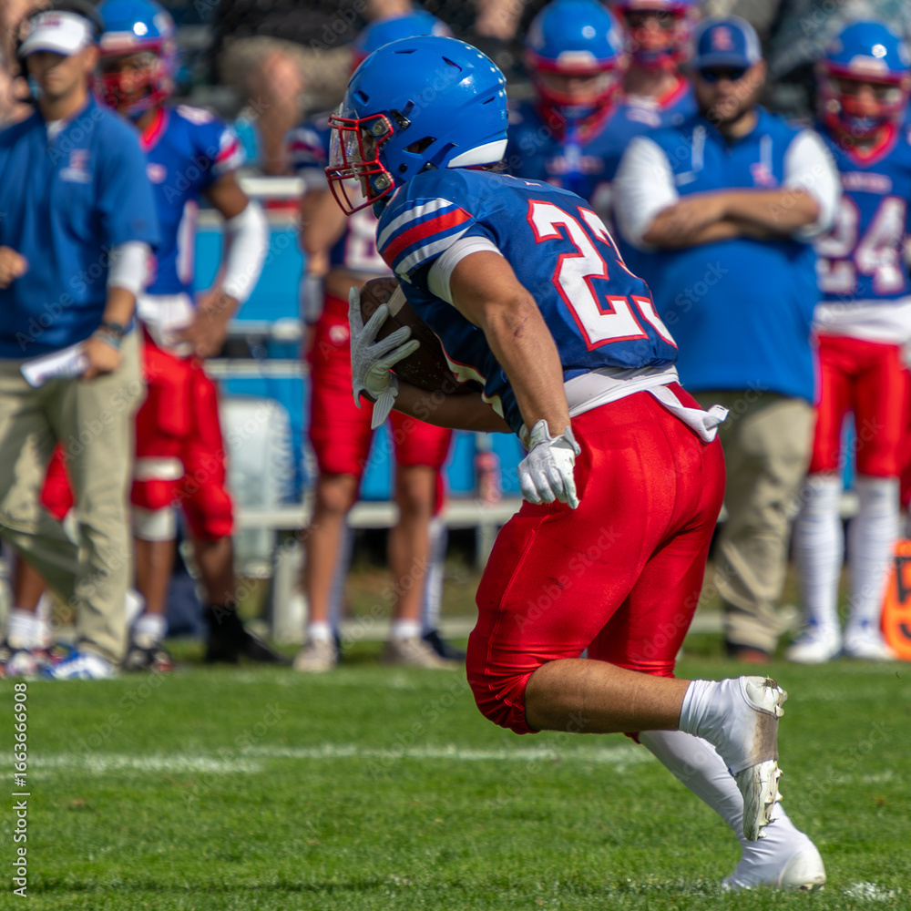 Fototapeta premium Running Back High School Football Boys of Fall Sports