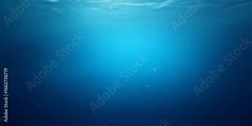 Diving deep into the blue ocean, sunlight creates abstract rays that illuminate the marine world's surface