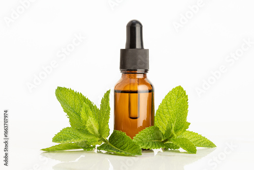 Peppermint essential oil on white background. Herbal remedies