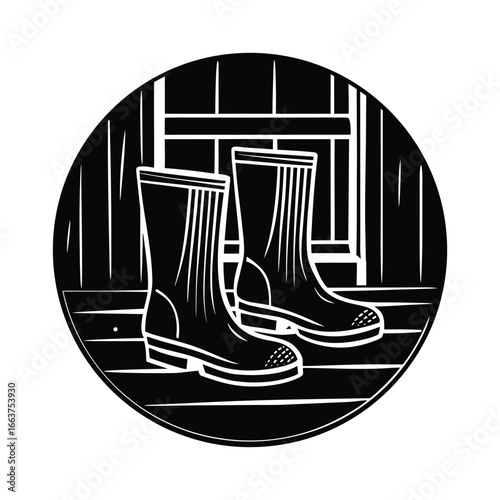 Pair of black rubber boots standing on wooden planks inside a circle