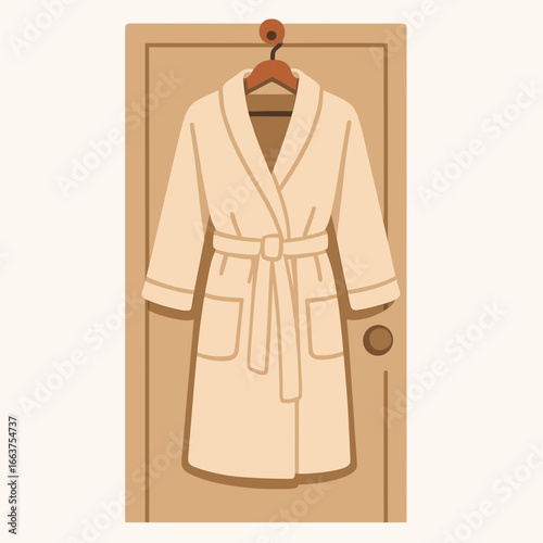 Bathrobe hanging on a wooden door with a simple design  