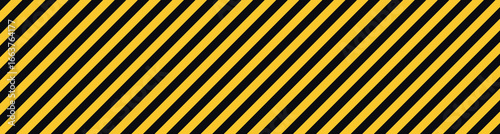 Yellow and black diagonal stripes background. Abstract warning texture with caution lines pattern. Hazard style backdrop for construction, safety, industrial design, and graphic decoration.