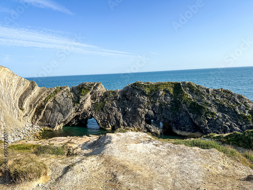 Jurassic coast view in Dorset, England, UK. Stair Hole near Lulworth Cove. Lulworth Cove cliffs view on a way to Durdle Door. The Jurassic Coast is a World Heritage Site on the English Channel coast