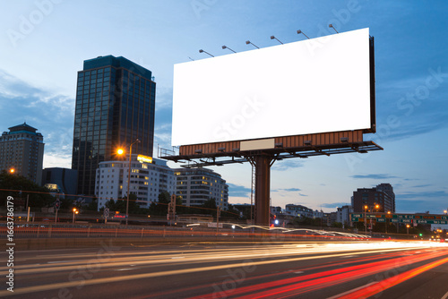 Billboard with Blank White Sign above Highway at Dusk | City Advertising Mockup for Marketing, Transportation, and Urban Development Campaigns