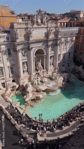 Stunning aerial footage showcases the iconic Trevi Fountain in Rome, highlighting its baroque architecture and vibrant waters that attract countless visitors, creating a memorable experience for all