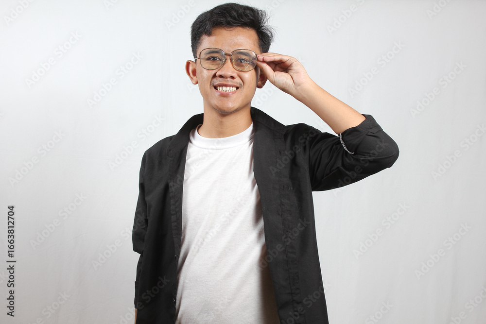 Authentic Portrait of Smiling Man Adjusting Eyeglasses in Casual Outfit Authentic Portrait of Smiling Man Adjusting Eyeglasses in Casual Outfit
