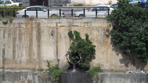 Wallpaper Mural A large pipe spilling raw sewage into a waterway Torontodigital.ca