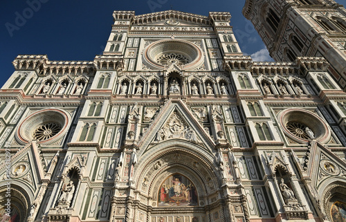 Bottom Up View To The Front Facade Of The Cathedral Of Florence Italy On A Wonderful Sunny Autumn Day With A Few Clouds In The Sky