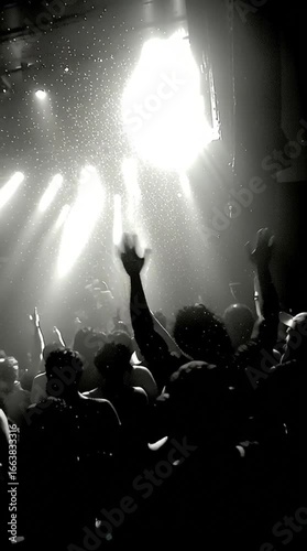 crowd of fans raising fists, dark livehouse floor chaotic with sweat and heat, monochrome cinematic filmic noise