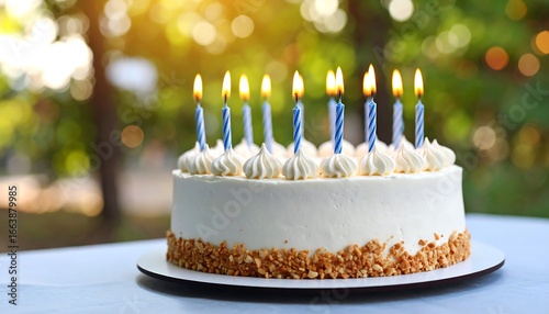 A delicious birthday cake with lit candles sits on a table, bathed in natural light.