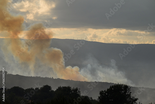 A Wildfire with a Wind Farm in the Distance. Concept The threat of fire to renewable energy.