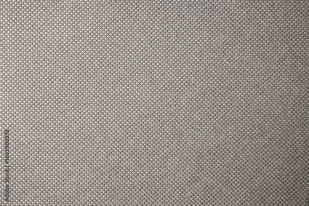 Fototapeta premium Intricate close-up texture of uniform silver-mesh like fabric background