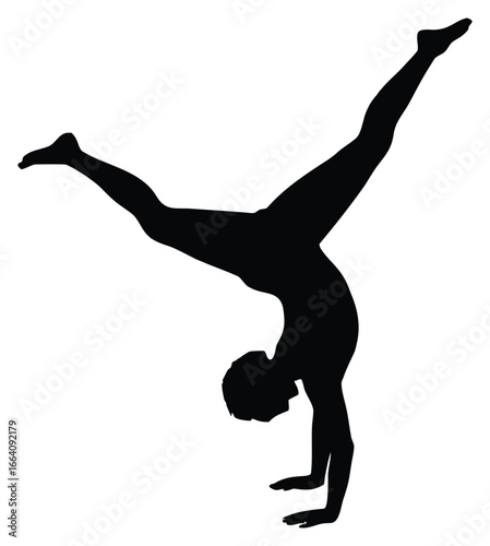 Silhouette of a gymnast performing handstand with legs split open gracefully