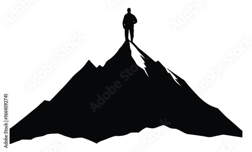 Silhouette of a man standing on top of a high mountain peak