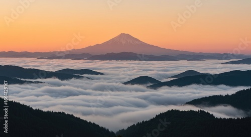 Distant volcano peak above a cloud inversion at sunrise