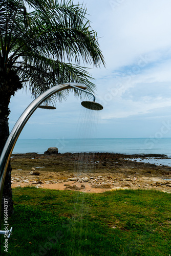 Tropical beach paradise outdoor shower with palm trees and sea views