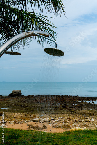 Tropical beach paradise outdoor shower with palm trees and sea views