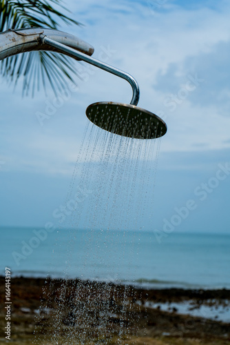 Tropical beach paradise outdoor shower with palm trees and sea views