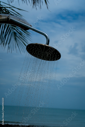 Tropical beach paradise outdoor shower with palm trees and sea views