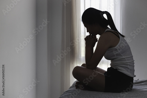 Bilde på lerret Asian woman sitting on the house area Feeling sad, tired and worried about depression, mental health problems and heartbreaking concept