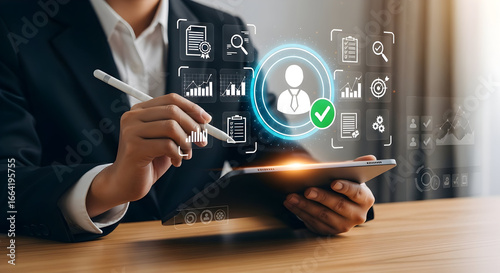 Businessperson analyzing data on a digital tablet.