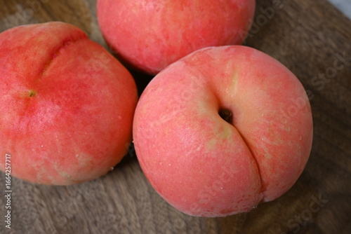 Close-up of fresh peaches on wooden surface