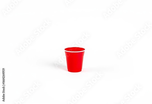 A single, bright red plastic cup sits on a plain white background, red plastic cup, white background