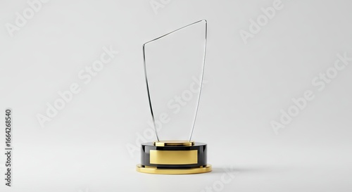 Glass trophy atop a black  gold base sits centerframe against a neutral backdrop