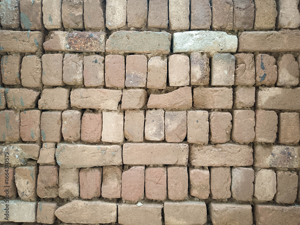 Obraz premium Rustic Brick Wall with Irregular Pattern, Weathered Texture, and Varied Brick Sizes