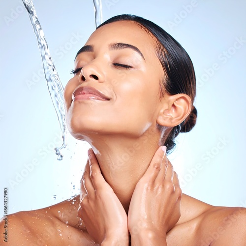 Woman with water cascading on her face and neck
