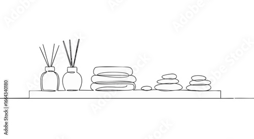 Relaxing spa scene with aromatherapy diffusers and stacked towels and zen stones.