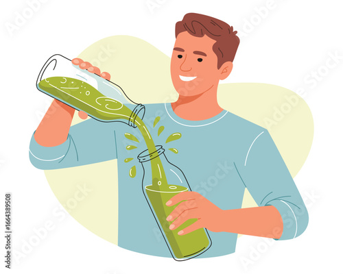 Healthy man pouring green juice from one bottle into another to show a healthy lifestyle