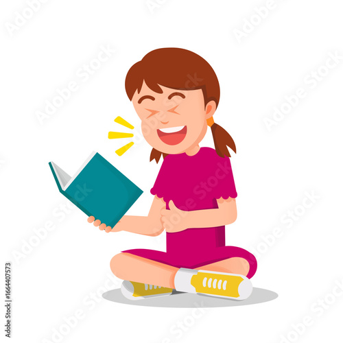 Little girl laughs out loud while reading a book