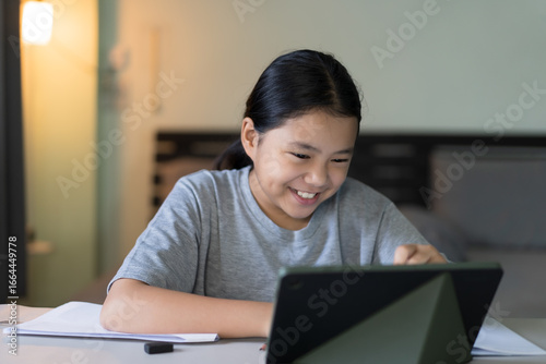 Bild auf Leinwand study online class by asian child smile learning on computer tablet or kid girl