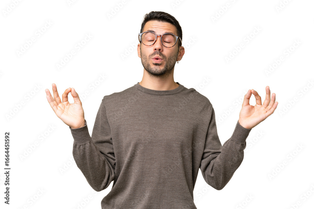 Naklejka premium Young handsome caucasian man over isolated background in zen pose
