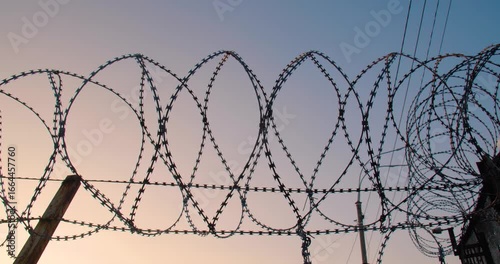 Background tracking shot of the cloudless sky over barbed wire for use in a composition for titles or titles, empty space for text or inscription.