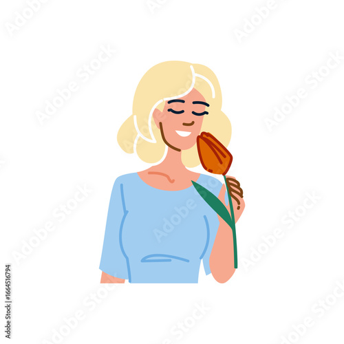 Blond woman smelling a tulip with closed eyes and smiling