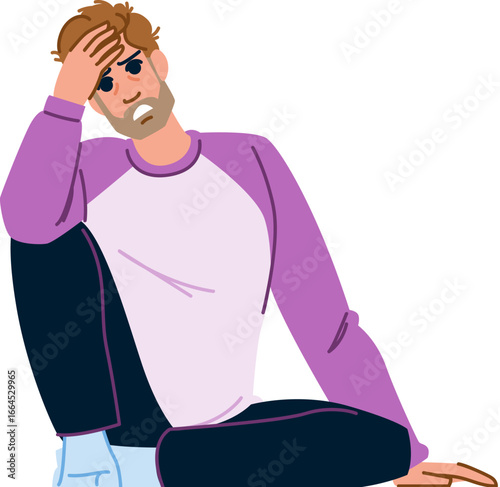 Stressed young man sitting on floor holding head with hand