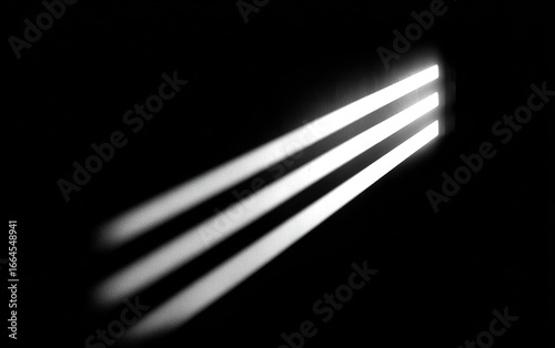 Three bright beams of light pierce a dark space