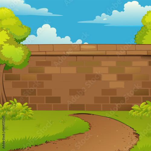 A brown brick wall with a dirt path and green grassy area