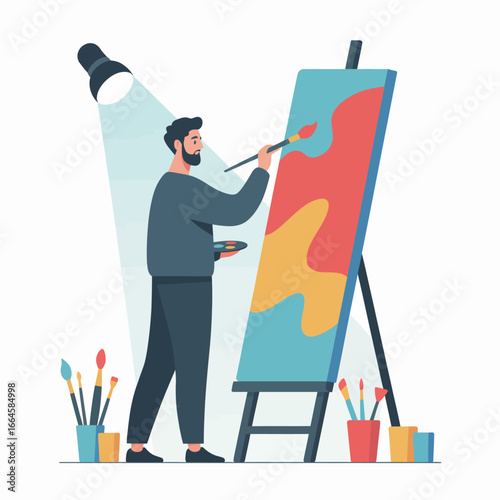 A bearded man stands painting on a large canvas, using a brush and palette, illuminated by a spotlight.