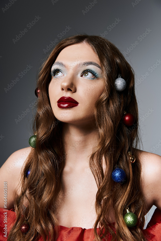 Fototapeta premium Brightly adorned young woman showcases artistic makeup and hairstyle while embracing the festive winter spirit.