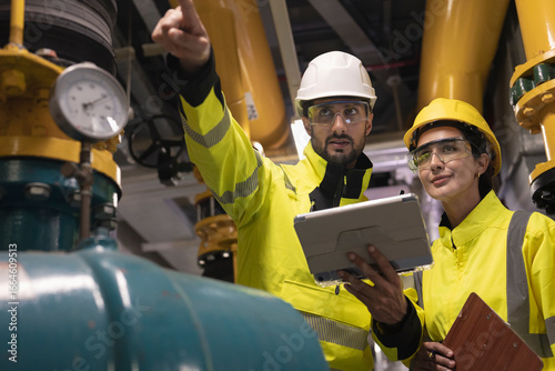 Industrial Cooling System Inspection Civil engineer manager and foreman worker conducting a thorough inspection of the building's industrial air conditioning and water cooling tower