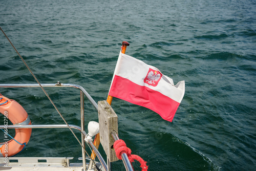 Gdynia, Pomerania, Poland - 28 June 2025: Polish flag on the stern of a tourist sea yacht