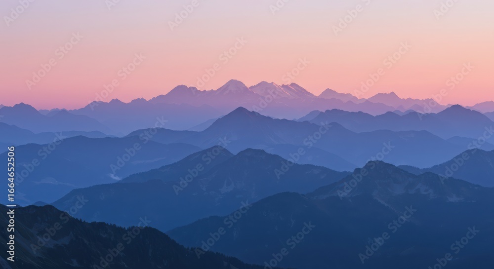 Obraz premium Layered mountain range at sunset with a soft pink and blue gradient sky