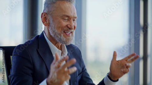 Aged manager enjoy videocall gesturing to laptop webcam in office closeup. 