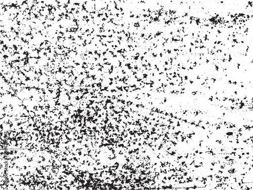 A high-contrast image reveals a detailed texture of small dark flecks and imperfections scattered across a bright surface, creating an abstract and distressed effect.