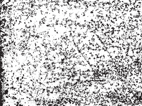 High-contrast, black and white image featuring a distressed texture. Small black spots are scattered across a white surface with faint lines forming a subtle geometric shape.