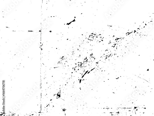 A high-contrast image showcasing a white surface with black marks. The texture is distressed, displaying scratches and scattered imperfections across the plane.